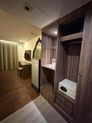 a room with a kitchen with a refrigerator and a table at The Beach Condotel Kata in Kata Beach