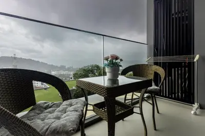 a table and chairs on a balcony with a view at Mida Grande Ocean View in Surin Beach