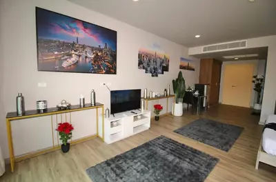a living room with a flat screen tv on a wall at Pool and See View Amazing Room in Karon Beach
