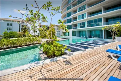 a swimming pool with a wooden deck and a building at Pool and See View Amazing Room in Karon Beach