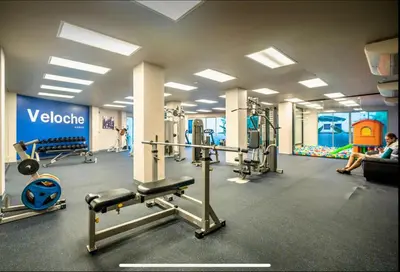 a gym with several machines and people in a room at Pool and See View Amazing Room in Karon Beach
