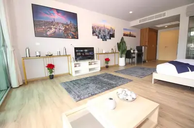 a large living room with a bed and a tv at Pool and See View Amazing Room in Karon Beach