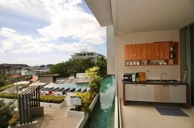 a kitchen with a view of the water from a balcony at Pool and See View Amazing Room in Karon Beach