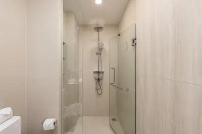 a shower with a glass door in a bathroom at Melia 2BR with Rooftop Pool - Skypark Laguna in Laguna Phuket