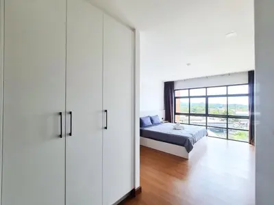 a bedroom with a bed and a large window at BP Sweet Home Bang Tao - 607 in Ban Thalat Choeng Thale