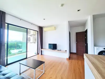 a living room with a couch and a table at BP Sweet Home Bang Tao - 607 in Ban Thalat Choeng Thale