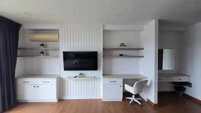 a room with a desk with a tv and a chair at BP Sweet Home Bang Tao - 607 in Ban Thalat Choeng Thale