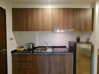 a small kitchen with a sink and a refrigerator at BP Sweet Home Bang Tao - Studio in Ban Thalat Choeng Thale