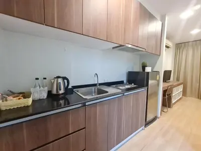 a kitchen with a sink and a refrigerator at BP Sweet Home Bang Tao - Studio in Ban Thalat Choeng Thale