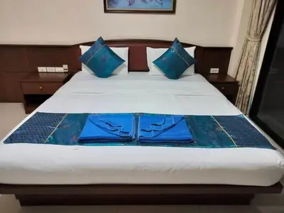 a bedroom with a bed with blue pillows at Hua LaiDe patong \u4e00\u5367\u5ba4\u5927\u5e8a\u623f in Patong Beach