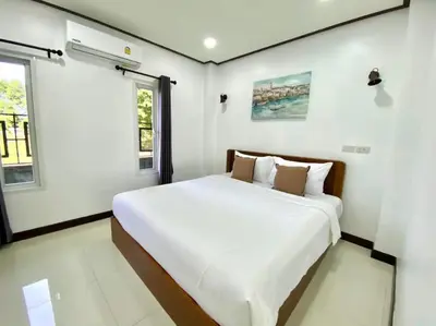 a bedroom with a large white bed in it at 365 Place Maikhao in Ban Mai Salae