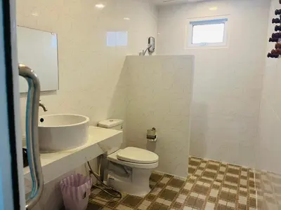 a bathroom with a white toilet and a sink at 365 Place Maikhao in Ban Mai Salae