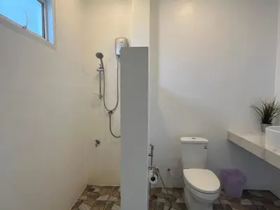 a bathroom with a toilet and a shower stall at 365 Place Maikhao in Ban Mai Salae