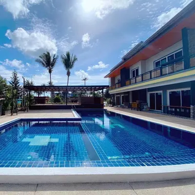 a swimming pool in front of a building at 365 Place Maikhao in Ban Mai Salae