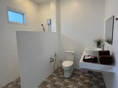 a white bathroom with a toilet and a sink at 365 Place Maikhao in Ban Mai Salae