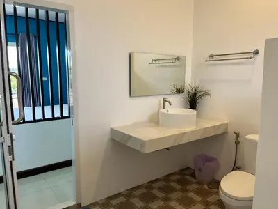 a bathroom with a sink and a toilet at 365 Place Maikhao in Ban Mai Salae