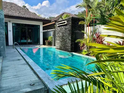 a swimming pool in front of a house at Stunning 3 Bedroom Pool Villa Kamala, Phuket in Kamala Beach