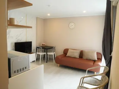 a living room with a couch and a table at Tower2 Condominium in Ban Klang