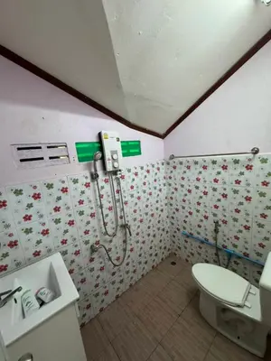 a bathroom with a toilet and a shower at Family house in Ban Laem Sai