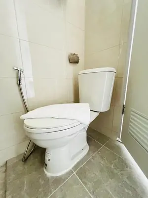 a bathroom with a white toilet in a room at Sarona House 4 in Ban Thalat Choeng Thale