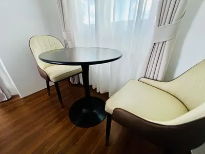 a table and two chairs in a room at Sarona House 4 in Ban Thalat Choeng Thale