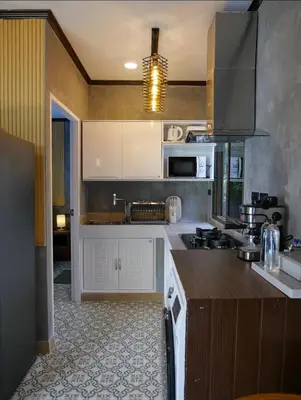 a kitchen with white cabinets and a counter top at Baan Ati Villas in Ban Han Pa To