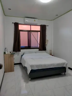 a bedroom with a large bed and a window at Soi Saliga in Rawai Beach
