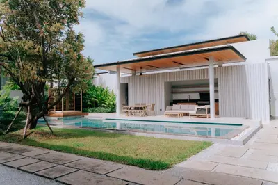 a house with a swimming pool in the backyard at Botanica Foresta B09 in Ban Phru Champa