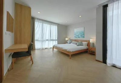 a bedroom with a bed and a desk in a room at Bangtao Luxury Pool Villa - PrymaSelva in Laguna Phuket