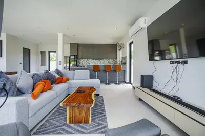 a living room with a couch and a table at Camellia Pool VillaNear Nai Harn And Rawai Beach in Ban Saiyuan (1)