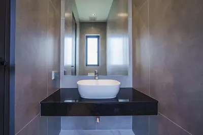 a bathroom with a sink and a mirror at Camellia Pool VillaNear Nai Harn And Rawai Beach in Ban Saiyuan (1)