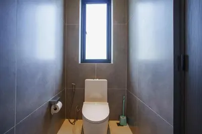 a bathroom with a toilet with a window above it at Camellia Pool VillaNear Nai Harn And Rawai Beach in Ban Saiyuan (1)