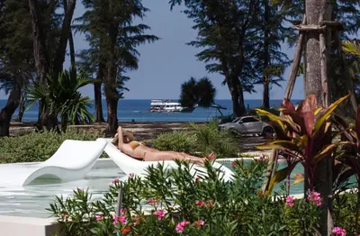 a person laying on a slide in the water at a resort at Sunshine Beach Appartments, 2BD in Layan Beach