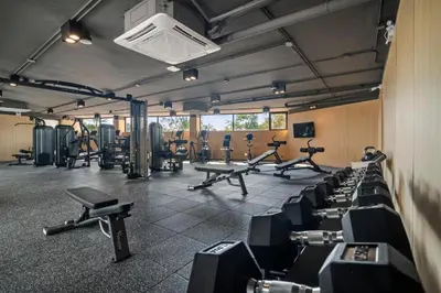 a gym with rows of exercise bikes and machines at Sunshine Beach Appartments, 2BD in Layan Beach
