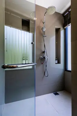 a shower with a glass door in a bathroom at Villa Laguna Park in Ban Thalat Choeng Thale