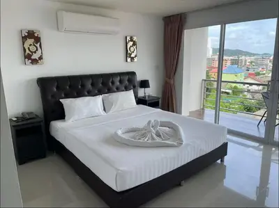a bedroom with a bed with a bowl on it at Smily Phuket Patong Sea View in Patong Beach
