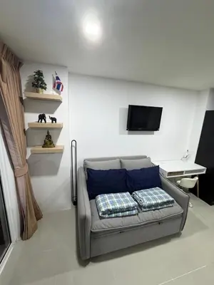 a living room with a couch and a tv at Smily Phuket Patong Sea View in Patong Beach
