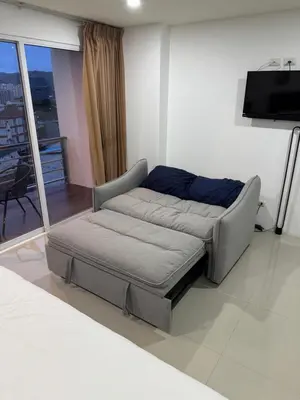 a bed in a living room with a tv at Smily Phuket Patong Sea View in Patong Beach