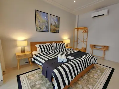 a bedroom with two beds and two night stands at Golden Andes \u8c6a\u534e\u5ea6\u5047\u522b\u5885 in Ban Mut Dok Khao
