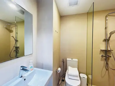 a bathroom with a sink and a toilet and a mirror at Cozy studio 1 bdr Golf view in Laguna Phuket