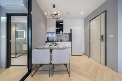 a kitchen with a table and two chairs and a refrigerator at The Title Legendary D-605 1 BR Bangtao Beach in Bang Tao Beach