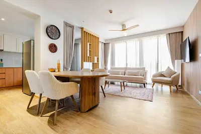a kitchen and living room with a table and chairs at Beachside by Villacarte in Bang Tao Beach