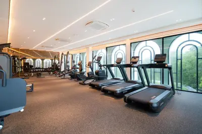 a gym with a row of treadms and elliptical machines at The Legendary Bang Tao 1-bedroom apart #711 in Bang Tao Beach