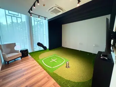 a room with a green carpet with a baseball field at The Legendary Bang Tao 1-bedroom apart #711 in Bang Tao Beach