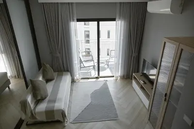 a living room with a couch and a sliding glass door at The Legendary Bang Tao 1-bedroom apart #711 in Bang Tao Beach