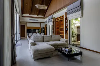 a living room with a couch and a table at Villa The Ozone in Ban Thalat Choeng Thale