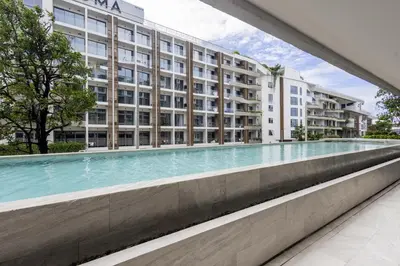 an empty swimming pool in front of a building at The SPACE Apartment 612 in Ban Thalat Choeng Thale