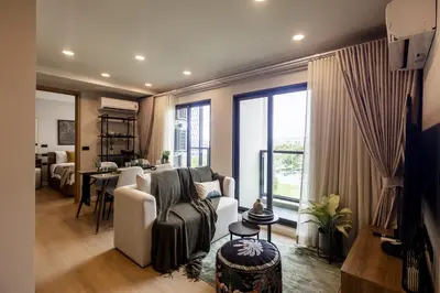 a living room with a couch and a table at The SPACE Apartment 612 in Ban Thalat Choeng Thale