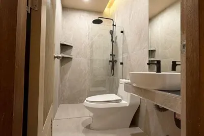 a bathroom with a toilet and a sink at Sand Maré Karon Hotel in Karon Beach