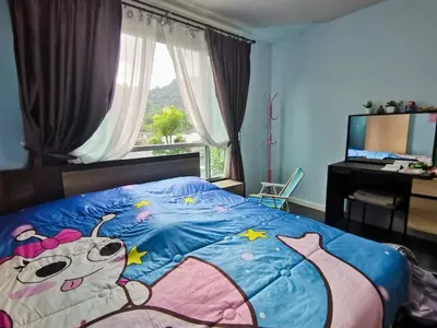 a bedroom with a large bed with a hello kitty blanket at Valley Mountain ViewCity Proximity Golden Eight Apartment in Phuket Town